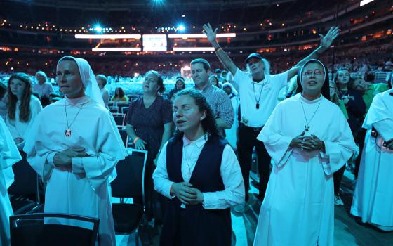 Pilgrims pray while listening to Catholic musician Matt Maher perform ahead of the beatification Mass for Venerable Fulton J. Sheen Sept. 24, 2026, at The Dome at America's Center in St. Louis. (OSV News/Bob Roller)