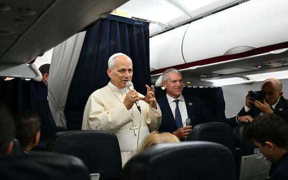 Pope Leo XIV speaks with journalists aboard his flight back to Rome Sept. 28, 2026, after concluding his Sept. 25-28 apostolic journey to France. The pope visited Paris, Saint-Denis, Lourdes and Metz during his trip. (CNS photo/Alberto Pizzoli, pool via Reuters)