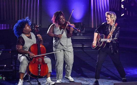 Brandi Carlile (right) performs with Monique Ross (far left) and Chauntee Ross of SistaStrings during the 55th annual Songwriters Hall of Fame Induction and Awards Gala at the Marriott Marquis Hotel on Thursday, June 11, 2026, in New York. (AP/Invision/Evan Agostini)