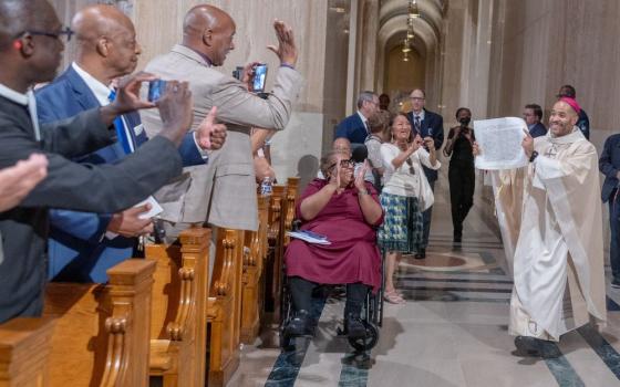 After being handed the apostolic letter from Pope Leo XIV appointing him as a new auxiliary bishop of Washington, Bishop Robert Boxie III displays the document during his ordination Mass July 7, 2026, at the Basilica of the National Shrine of the Immaculate Conception in Washington. (OSV News/Catholic Standard/Mihoko Owada)