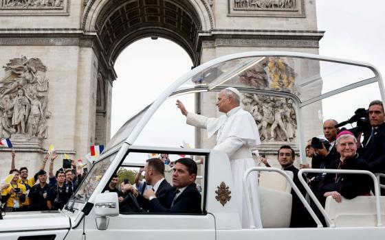 Pope Leo XIV travels in the popemobile on the Champs-Élysées near the Arc de Triomphe to celebrate an open-air Mass at the Place de la Concorde during his four-day apostolic journey to France, Sept. 26, 2026. (OSV News/Reuters/Benoit Tessier)