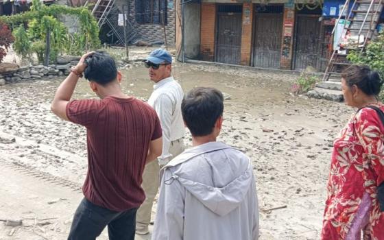 Members of an assessment team by the Sisters of Charity of Nazareth, Kathmandu, and the Nepal Jesuit Social Institute tour flood-affected areas in the Galchi rural municipality of Dhading, a largely agricultural area in northeast Nepal. (Courtesy of Sisters of Charity of Nazareth, Kathmandu)