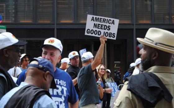 A participant holds up a sign during the Sept. 10, 2022, Labor Day parade in New York City. (Dreamstime/Erin Alexis Randolph)