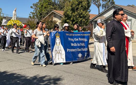 A banner in front of a statue of Our Lady of Fatima bears the words “Pray the Rosary, Walk in Faith, Protect Our Families,” during a procession in support of immigrants in San Jose, California, Sept.13, 2026. (Marissa Nichols)