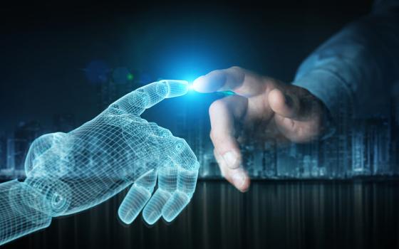 Human hand touches a blue digital hand (Dreamstime/Sdecoret)
