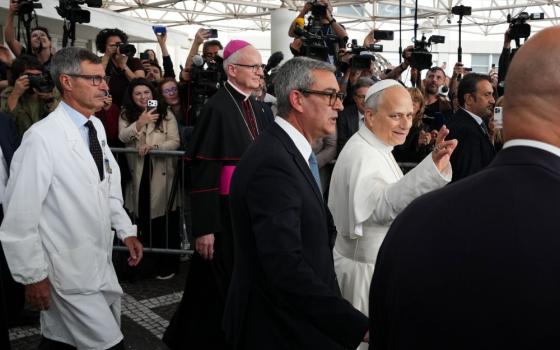 Pope Leo XIV, followed by surgeon Stefano Margaritora, Archbishop Petar Rajič, prefect of the Papal Household, and Commander of the Vatican Gendarmerie Gianluca Gauzzi Broccoletti, leaves Rome's Agostino Gemelli Polyclinic on Oct. 17, 2026, after surgery Oct. 13 to remove lung cancer. (AP/Alessandra Tarantino)