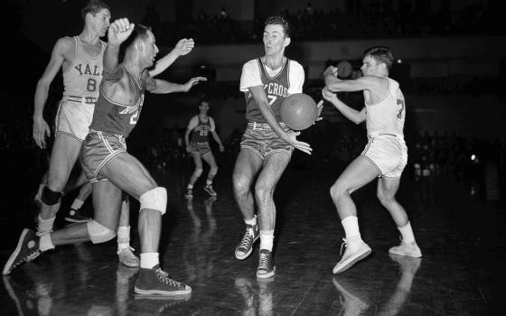 Bob Cousy, Holy Cross forward, second from right, intercepts a pass during an NCAA college basketball game Feb. 19, 1949, in New Haven, Conn. (AP/File)