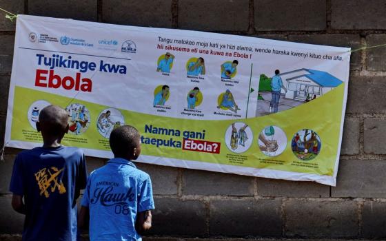 Congolese children read an advocacy poster in Bunia, Congo, May 20, 2026, as aid agencies intensify efforts to contain a new Ebola outbreak caused by the Bundibugyo strain outbreak. (OSV News/Reuters/Gradel Muyisa Mumbere)