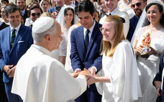 Pope Leo XIV greets a newlywed couple in St. Peter's Square at the Vatican after his weekly general audience Sept. 9, 2026. (CNS/Vatican Media)