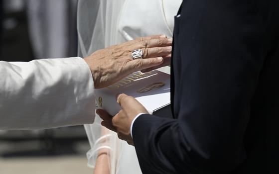Pope Leo XIV blesses a Bible dedicated to married couples at the Vatican after his weekly general audience June 4, 2025. (CNS/Vatican Media)