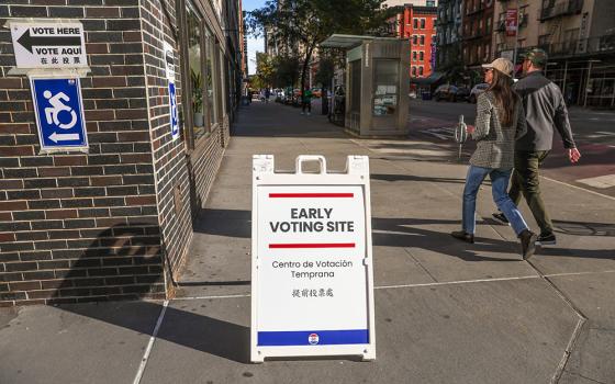 Pedestrians walk past street signage on the first day of early voting in New York, on Saturday, Oct. 24, 2026. (AP/Heather Khalifa)