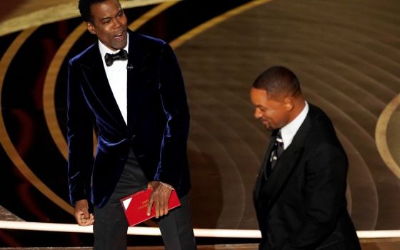 The comedian Chris Rock, left, reacts after actor Will Smith slaps him onstage during the 94th Academy Awards at the Dolby Theatre in Los Angeles March 27. (AP/Chris Pizzello)