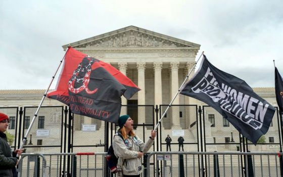 Protesters wave flags during a demonstration outside of the U.S. Supreme Court, Sunday, May 8, 2022, in Washington, D.C. A leaked draft opinion suggests the Supreme Court could be poised to overturn Roe v. Wade. 
