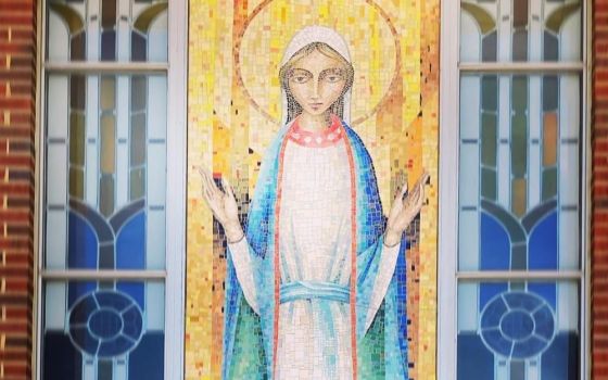 A large mosaic of Our Lady on the exterior of Notre Dame Parish in Michigan City, Indiana, greets riders at the end of the 100-kilometer Pat Mac Pack Ride fundraising ride to benefit those with pediatric brain cancer. (Mark Piper)