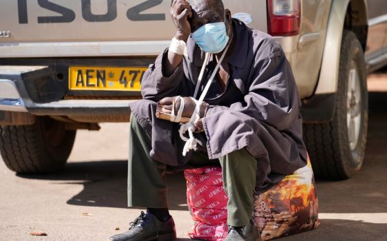 A man sits after being refused medical assistance at Parirenyatwa Hospital in Harare, Zimbabwe, June 21. A strike by health workers has left Zimbabwe's major hospitals in near paralysis. (AP/Tsvangirayi Mukwazhi)