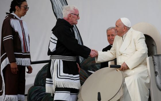 Elder Piita Irniq and youth drum dancer Malachai Angulalik Mala present Pope Francis with a traditional drum during a meeting with young people and elders outside the primary school in Iqaluit in the Canadian territory of Iqaluit, Nunavut, July 29. 
