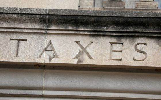 The word "taxes" is seen engraved on the headquarters of the Internal Revenue Service in Washington, D.C., May 10, 2021. The Inflation Reduction Act, passed by both houses of Congress, includes $80 billion for the Internal Revenue Service.