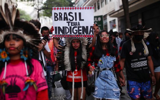 Indigenous people march with a placard that says "Brazil Indigenous Land" as they mark the International Day of the World's Indigenous Peoples in São Paulo Aug. 9. Cardinal Leonardo Steiner said that the Amazon region is seeing an increase in violence.