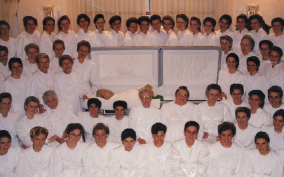 The wives of Rulon Jeffs attend his funeral in this photo featured in the documentary "Keep Sweet: Pray and Obey" on Netflix. He had the words "Keep sweet" affixed to the soles of his shoes. (Courtesy of Netflix © 2022) 