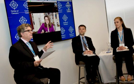 From left: Kevin Locke, Kerry Alys Robinson (onscreen), Massimo Faggioli and Jordan Denari Duffner discuss the pontificate of Pope Francis March 13 at Center of Concern headquarters in Washington, D.C. (Center of Concern/Michael Carpenter Photography)