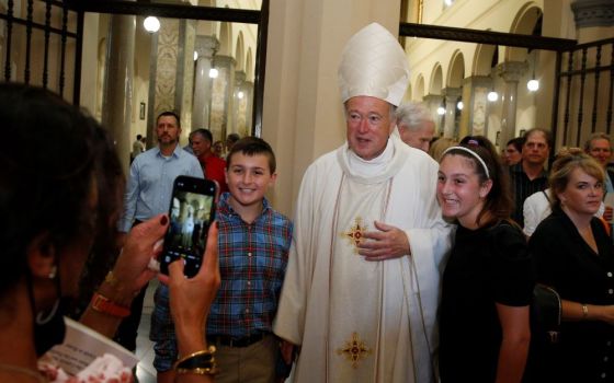 New Cardinal Robert W. McElroy of San Diego takes a photo with people after celebrating a Mass of thanksgiving at St. Patrick's Church, official home of the U.S. Catholic community in Rome, Aug. 28. (CNS/Paul Haring)