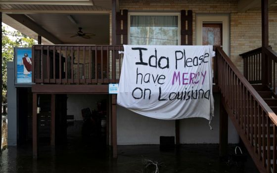 A blanket hangs outside a house in Jean Lafitte, La., Sept. 2 following Hurricane Ida's landfall. (CNS/Reuters/Marco Bello)