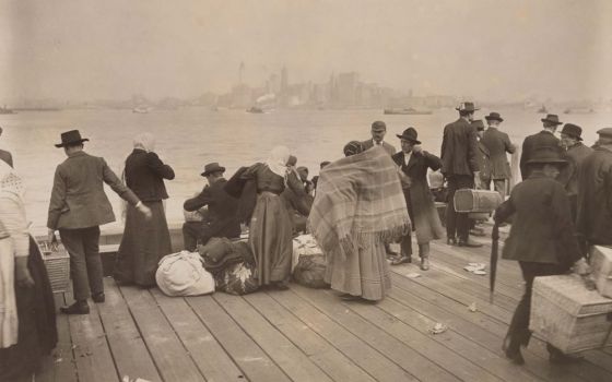 Immigrants wait at Ellis Island to be transferred Oct. 30, 1912. (PBS/ Library of Congress)