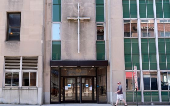 A man walks by the offices of the Diocese of Rockville Centre Oct. 1, 2020. Rockville Centre was the fourth New York diocese to file for bankruptcy because of financial pressure from lawsuits over past sexual abuse by clergy members. New York's