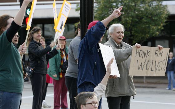 Demonstrators take part in a wolf hunt protest in Madison, Wisconsin, in 2013. Environmental and Native American groups have filed lawsuits in an effort to stop this year's hunt. (The Capital Times/Michelle Stocker via AP)