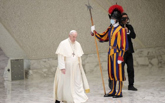 Pope Francis walks past a Vatican Swiss Guard as he arrives for his weekly general audience in the Paul VI hall, at the Vatican, Wednesday, Sept. 8, 2021. (AP Photo/Andrew Medichini)