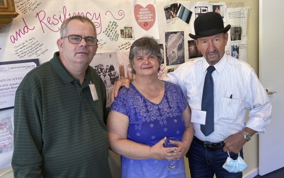 Michael Ryan, of Buckingham, Va., Brenda Hannon, of Williston, Vt. and John Magnago, of Miami, from left to right, pose in South Burlington, Vt., during a reunion of orphans from the St. Joseph's Orphanage in South Burlington, Vt., Thursday, Sept. 16, 202