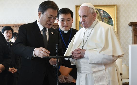 South Korea's President Moon Jae-in exchanges gifts with Pope Francis as they meet at the Vatican, Friday, Oct. 29, 2021. (Vatican Media via AP)