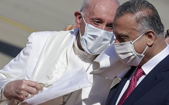 Pope Francis is greeted by Iraqi Prime Minister Mustafa al-Kadhimi as he arrives at Baghdad's international airport, Iraq, on March 5, 2021. (AP Photo/Andrew Medichini)