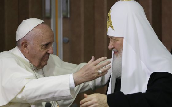 Pope Francis, left, reaches to embrace Russian Orthodox Patriarch Kirill after signing a joint declaration at the Jose Marti International airport in Havana, Cuba, Friday, Feb. 12, 2016. (AP Photo/Gregorio Borgia, Pool, File)