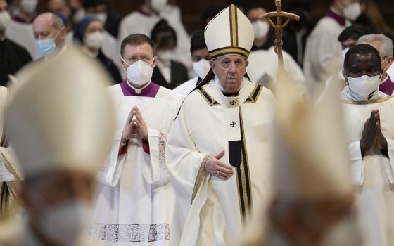 Pope Francis walks with his pastoral staff among Cardinals and prelates wearing FFP2 masks at the end of an Epiphany Mass in St. Peter's Basilica Jan. 6 at the Vatican. (RNS/AP/Gregorio Borgia)