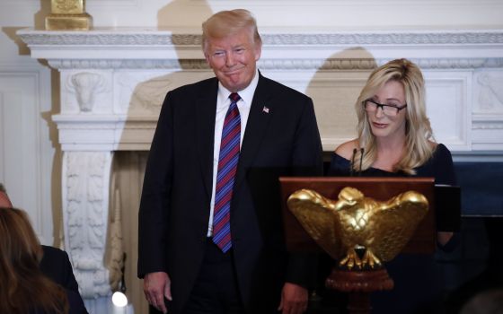 Then-President Donald Trump with pastor Paula White at a dinner for evangelical leaders in the State Dining Room of the White House, Aug. 27, 2018, in Washington. (AP/Alex Brandon)