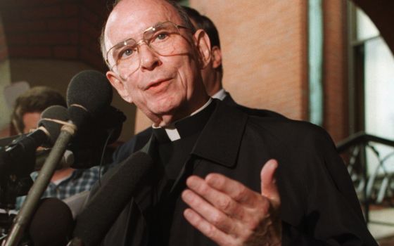 In this Sept. 23, 1996 file photo, Cardinal Joseph Bernardin speaks with reporters on the steps of his Chicago residence just before his departure for Rome to meet with Pope John Paul II. (AP Photo/Peter Barreras, File)