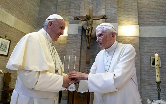 In 2017, Pope Francis, left, and Pope Emeritus Benedict XVI meet on the occasion of the elevation of five new cardinals at the Vatican. (RNS/Pool photo via AP, File/L'Osservatore Romano)