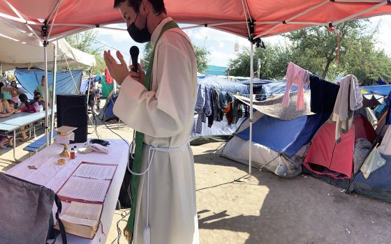 A panoramic view of the Rev. Louie Hotop leading Mass for at a migrant camp in Reynosa, Mexico. (RNS/Courtesy photo)