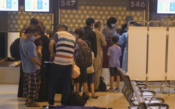 Evacuees from Afghanistan queue in line after arriving at Rome's Leonardo da Vinci international airport in Fiumicino Aug. 24. (AP/Paolo Santalucia)