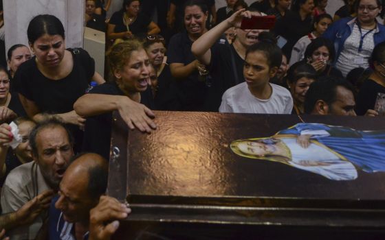 Mourners attend a memorial service for victims of a fire at a church in Greater Cairo that killed dozens on Aug. 14. (AP/Tarek Wajeh)