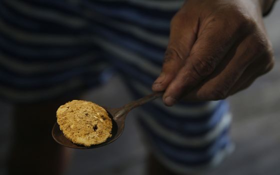 An illegal miner shows gold extracted from the Madeira River, in Nova Olinda, Amazonas state, Brazil, on Nov. 26. (AP/Edmar Barros)