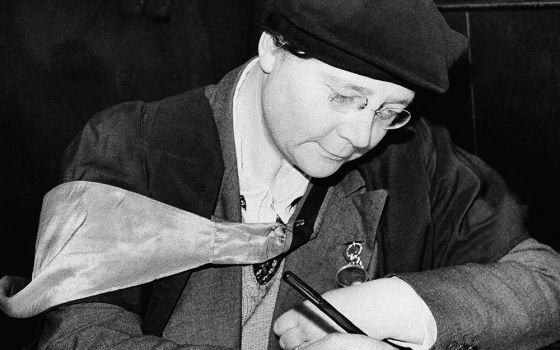 Dorothy L. Sayers signs a visitors' book Feb. 6, 1942, at St. Martin-in-the-Fields church in London, where she addressed the congregation at a lunchtime service. (AP Photo)