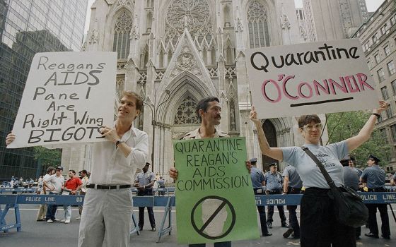 Demonstrators hold signs in front of St. Patrick's Cathedral in New York City on Aug. 2, 1987, to protest the appointment of Cardinal John O'Connor to a national AIDS panel, which gay rights activists said was "stacked" against them. (AP/Mario Cabrera)