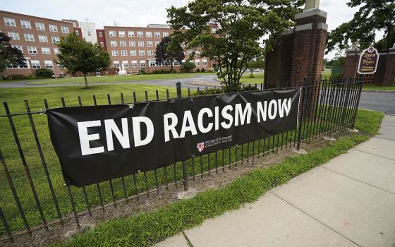 An anti-racism banner created by the Sisters of St. Dominic of Amityville, New York, is seen July 22 near the main gate to the religious community's motherhouse. (CNS/Gregory A. Shemitz)