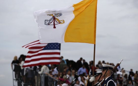 Vatican and U.S. flags are held by a military color guard during ceremonies welcoming Pope Francis upon his arrival at Joint Base Andrews outside Washington Sept. 22, 2015. (CNS/Reuters/Jonathan Ernst)
