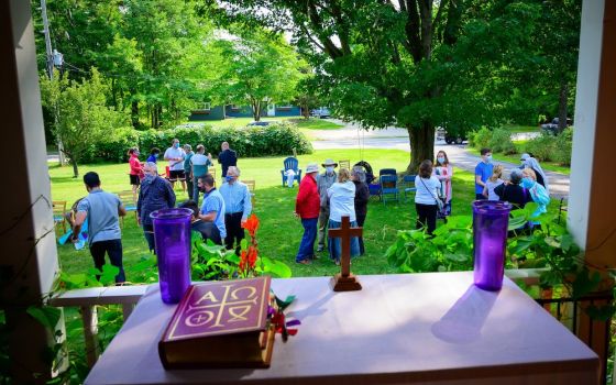 People spend time in conversation following the outdoor Mass at the home of Larry and Diane Kahlscheuer on Washington Island, Wisconsin, Sept. 6. (CNS/The Compass/Sam Lucero)