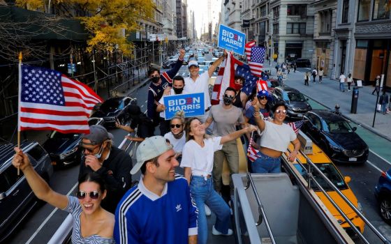 People ride down Fifth Avenue in New York City Nov. 8, a day after the news media declared Democrat Joe Biden declared the winner of presidential election. (CNS/Reuters/Andrew Kelly)