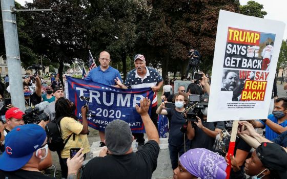 A Trump supporter in Kenosha, Wisconsin, exchanges words with protesters Sept. 1, during President Donald Trump's visit there. (CNS/Reuters/Kamil Krzaczynski)