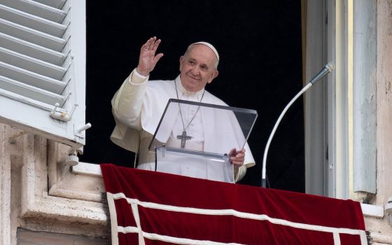 Pope Francis greets the crowd as he leads the Angelus from the window of his studio overlooking St. Peter's Square at the Vatican Oct. 11. (CNS/Vatican Media)